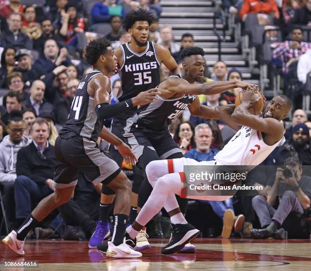 Harry Giles III, Marvin Bagley III, and Buddy Hield of the Sacramento Kings battle against Serge Ibaka of the Toronto Raptors in an NBA game at...