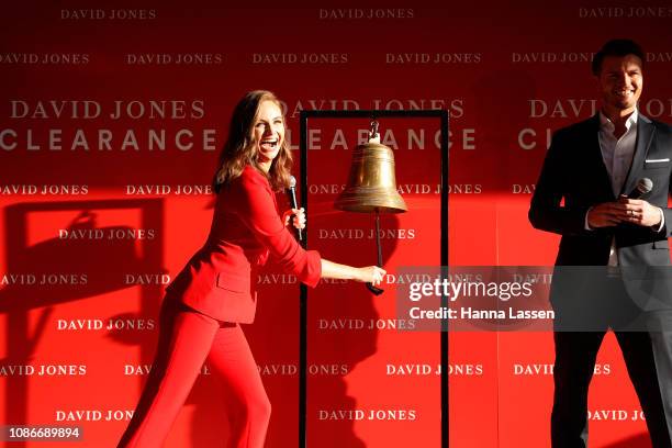 Ksenija Lukich rings the bell with Shawn Dooley outside of the David Jones Elizabeth St store during the Boxing Day sales on December 26, 2018 in...