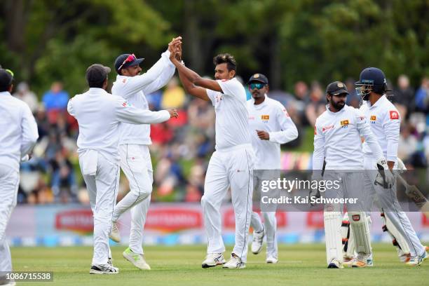 Suranga Lakmal of Sri Lanka is congratulated by team mates after dismissing Tom Latham of New Zealand during day one of the Second Test match in the...