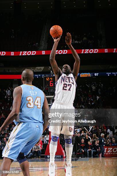 Johan Petro of the New Jersey Nets shoots against Melvin Ely of the Denver Nuggets during game on January 31, 2011 at Prudential Center in Newark,...