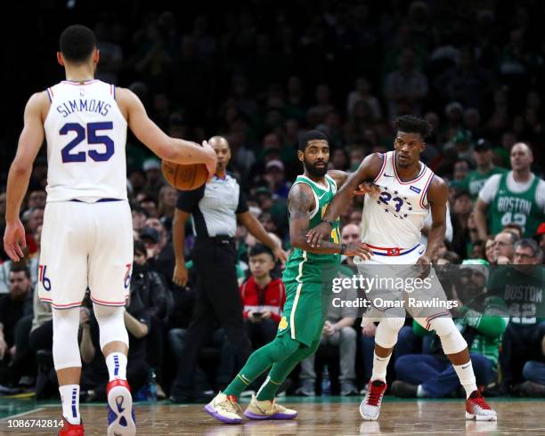 Ben Simmons of the Philadelphia 76ers brings the ball up court as Jimmy Butler of the Philadelphia 76ers fights for position against Kyrie Irving of...