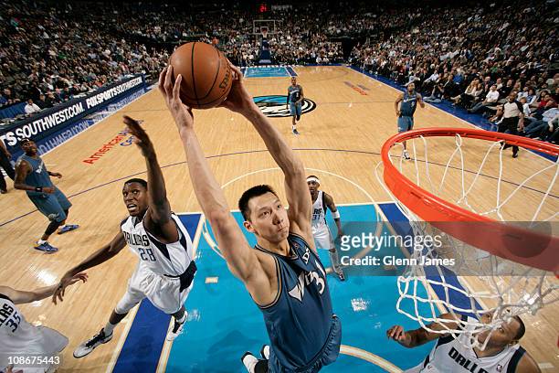 Yi Jianlian of the Washington Wizards dunks against Ian Mahinmi of the Dallas Mavericks on January 31, 2011 at the American Airlines Center in...