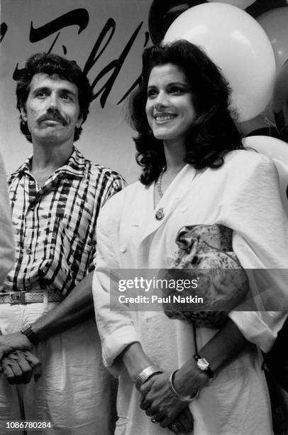 Actors Edward James Olmos and Saundra Santiago promote their television show 'Miami Vice' during a visit to a department store in Chicago, Illinois,...