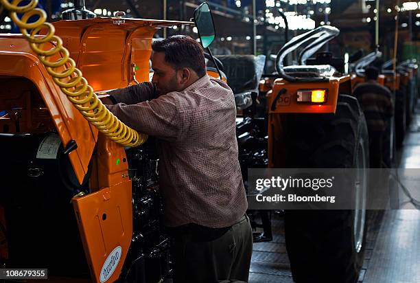 An employee works on the assembly line at Sonalika Group's International Tractors Ltd. Plant in Hoshiarpur, Punjab, India, on Saturday, Jan. 29,...