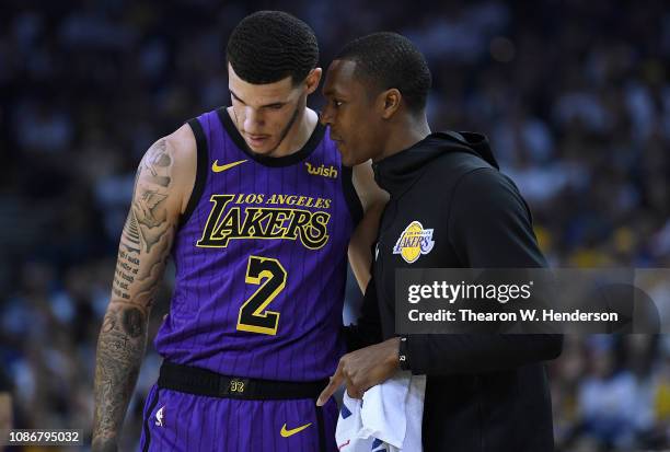 Lonzo Ball of the Los Angeles Lakers listens to teammate Rajon Rondo against the Golden State Warriors during the first half of their NBA Basketball...