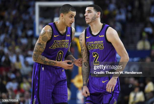 Lonzo Ball of the Los Angeles Lakers listens to teammate Kyle Kuzma against the Golden State Warriors during the second half of their NBA Basketball...