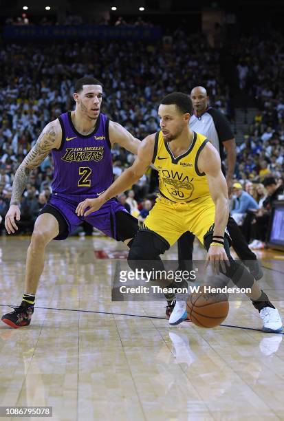 Stephen Curry of the Golden State Warriors drives on Lonzo Ball of the Los Angeles Lakers during the second half of their NBA Basketball game at...