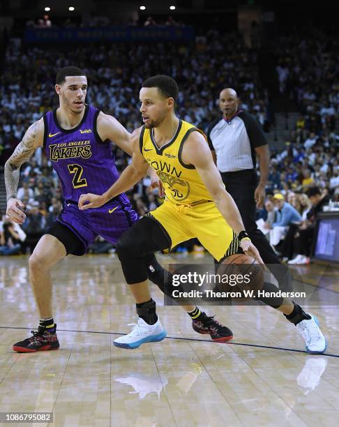 Stephen Curry of the Golden State Warriors drives on Lonzo Ball of the Los Angeles Lakers during the second half of their NBA Basketball game at...