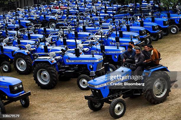 Drivers park tractors in a parking bay outside Sonalika Group's International Tractors Ltd. Plant in Hoshiarpur, Punjab, India, on Saturday, Jan. 29,...