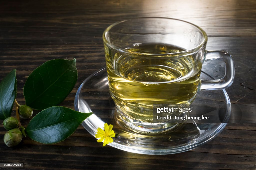 Glass green tea cup set on old table top