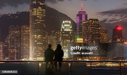 Young couple looking at city lights Young couple looking at city lights