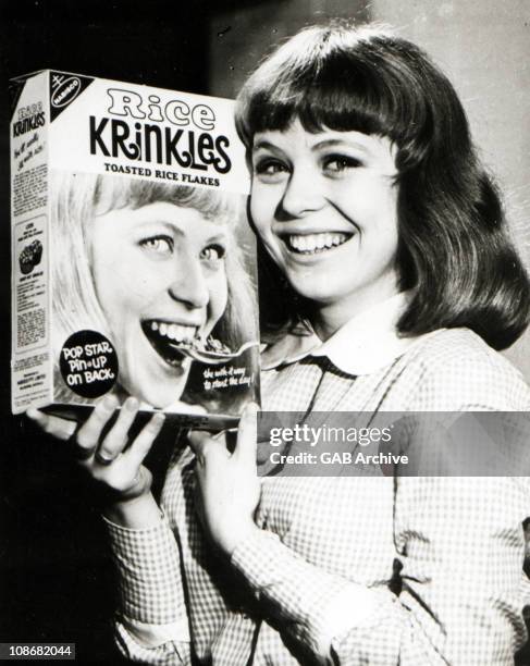 Photo of Australian actor Jacki Weaver posing with a box of cereal circa 1965