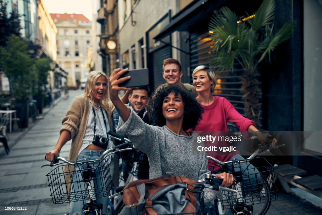 Friends Riding Bicycles In A City