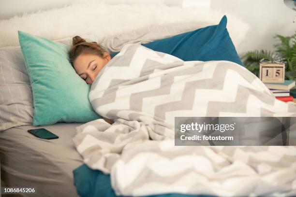 woman sleeping tucked in a warm blanket - wrapped in a blanket stock pictures, royalty-free photos & images