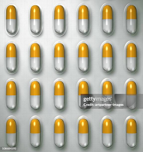 yellow - white capsules in a blister pack - blister pack stock pictures, royalty-free photos & images