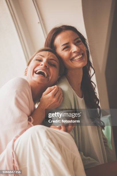 women having fun time at home - mature women friendship stock pictures, royalty-free photos & images