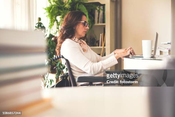 Woman in wheelchair working freelance