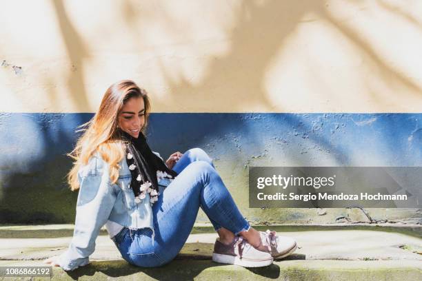 one young hispanic woman sitting on the floor in mexico city, mexico - fashion woman floor cross legged stock pictures, royalty-free photos & images