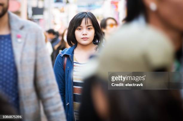 alone in a crowd - crowd of people walking stock pictures, royalty-free photos & images