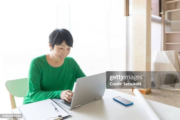 asian businesswoman with a laptop computer - n tech stock pictures, royalty-free photos & images