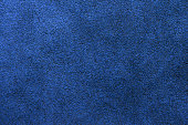 Dark blue suede background.