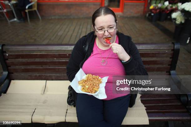 Woman eats take away chips on the streets of Oldham where the council are considering imposing a tax on take away food outlets on February 1, 2011 in...