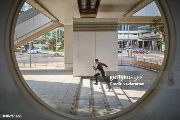 businessman running on steps in city - businessman running stock pictures, royalty-free photos & images