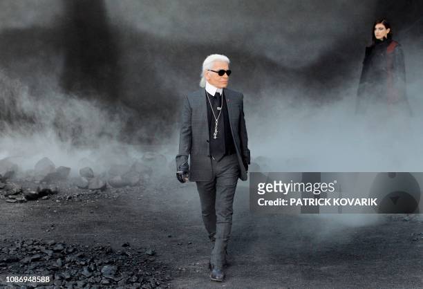 German designer Karl Lagerfeld acknowledges the public following the Chanel Autumn/Winter 2011-2012 ready-to-wear collection show on March 8, 2011 in...