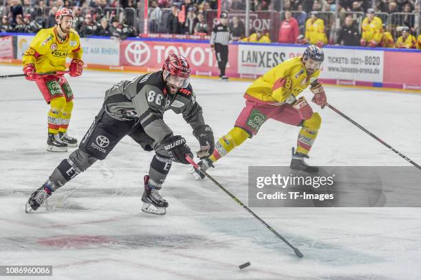 Ben Hanowski of Koelner Haie and Marco Nowak of Düsseldorfer EG battle for the ball during the DEL match between Koelner Haie and Duesseldorfer EG at...