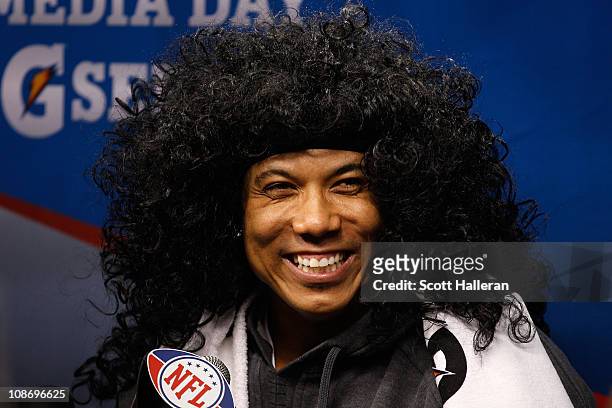 Hines Ward of the Pittsburgh Steelers smiles as he wears a Troy Polamalu wig as he is on the podium during Super Bowl XLV Media Day ahead of Super...