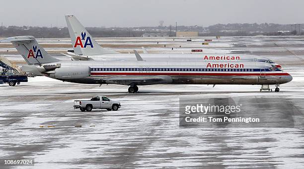 American Airlines jets sit idle after an overnight ice storm forced the closure of DFW International Airport on February 1, 2011 in Dallas, Texas. A...