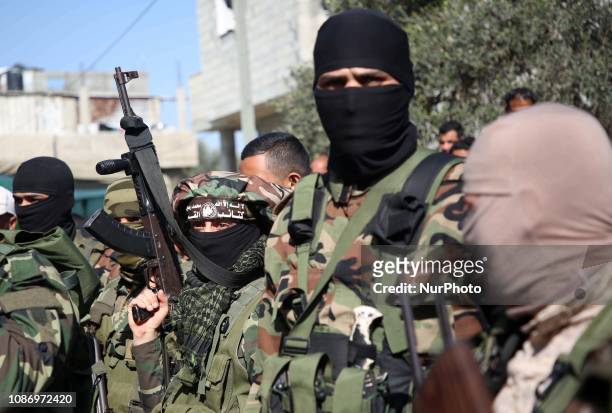 Palestinian Hamas militants take part in the funeral of their comrade Mahmoud Al-Nabaheen during his funeral in the central Gaza Strip January 23,...