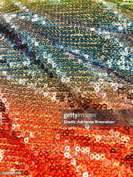 cascading sequins fabric in orange, blue, and green - sequin stock pictures, royalty-free photos & images