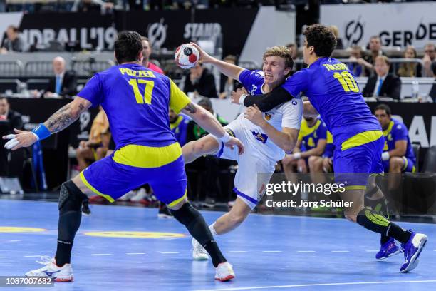 Gigli Thorgeir Kristjansson of Iceland is challenged by Jose Toledo during the Main Group 1 match at the 26th IHF Men's World Championship between...
