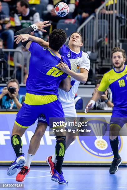 Jose Toledo of Brazil is challenged by Bjarki Mar Elisson of Iceland during the Main Group 1 match at the 26th IHF Men's World Championship between...