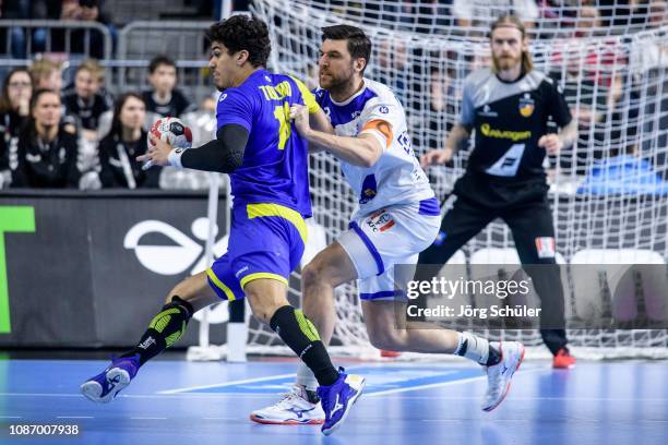 Jose Toledo of Brazil is challenged by Olafur Gustafsson during the Main Group 1 match at the 26th IHF Men's World Championship between Brazil and...