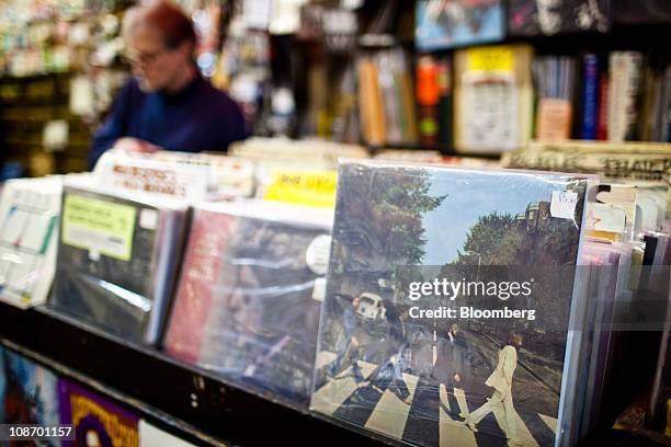The Beatles "Abbey Road" album is displayed for sale while a customer browses at Bleeker Bob's record shop in New York, U.S., on Tuesday, Feb. 1,...