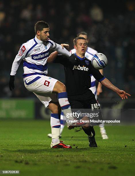 Adel Taarabt of QPR gets past Jonathan Hogg of Portsmouth during the npower Championship match between Queens Park Rangers and Portsmouth at Loftus...