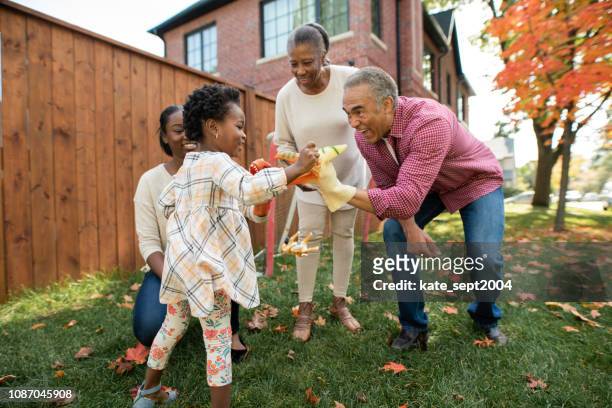 grandparents, parent and granddaughter together - multi generation family stock pictures, royalty-free photos & images