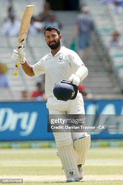 Cheteshwar Pujara of India raises his bat after scoring 100 runs during day two of the Third Test match in the series between Australia and India at...