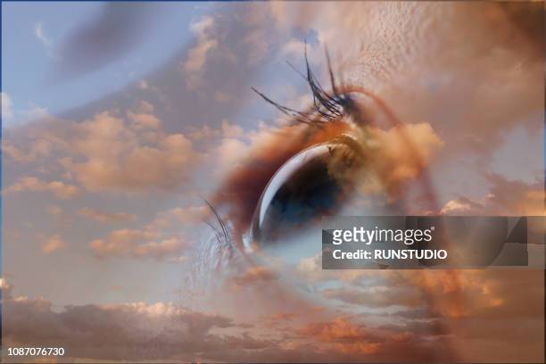 double exposure of eye and  cloudy sky - double exposure face stock-fotos und bilder
