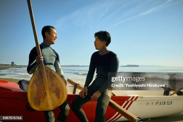 men sitting on canoe and talking togather. - asian team sport stock pictures, royalty-free photos & images