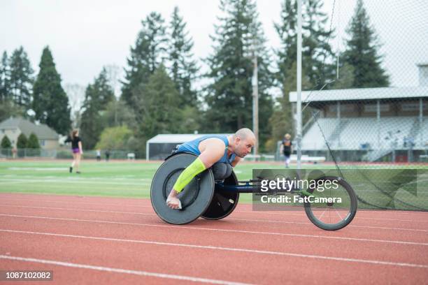 adaptive athlete training on his racing wheelchair - wheelchair athlete stock pictures, royalty-free photos & images