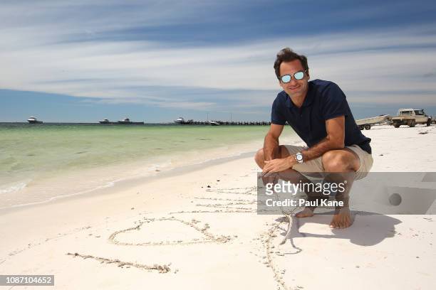 Roger Federer signs I Love WA on the beach ahead of the 2019 Hopman Cup at The Lobster Shack on December 27, 2018 in Cervantes, Australia.