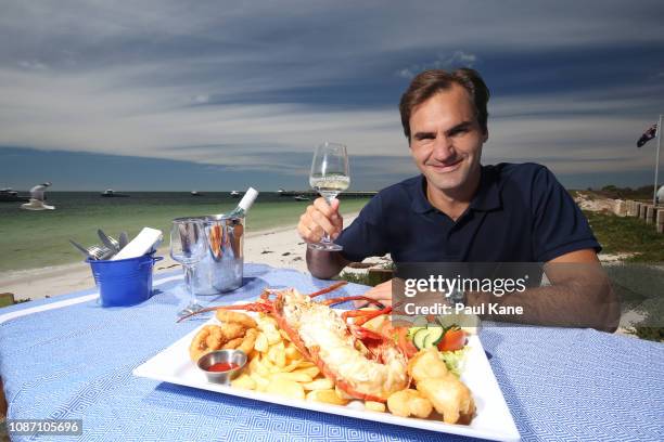 Roger Federer enjoys a seafood feast on the beach at The Lobster Shack ahead of the 2019 Hopman Cup on December 27, 2018 in Cervantes, Australia.