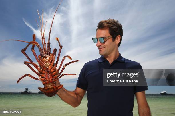 Roger Federer holds a Western Rock Lobster on the beach at The Lobster Shack ahead of the 2019 Hopman Cup on December 27, 2018 in Cervantes,...