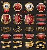 Collection of elegant red and gold anniversary badges and labels design elements