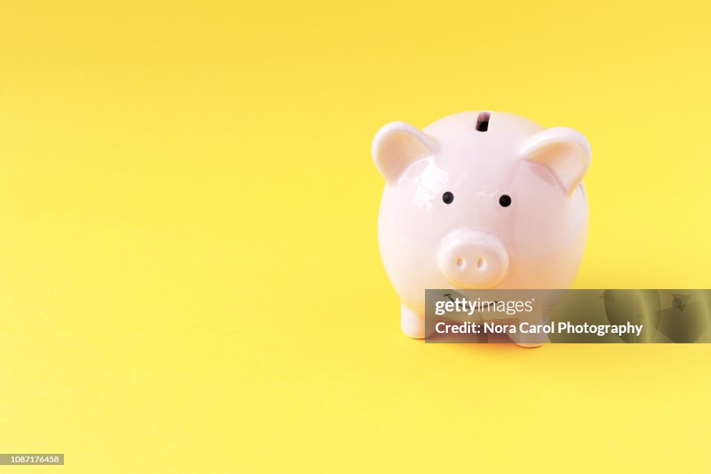 Piggy Bank on Yellow Background