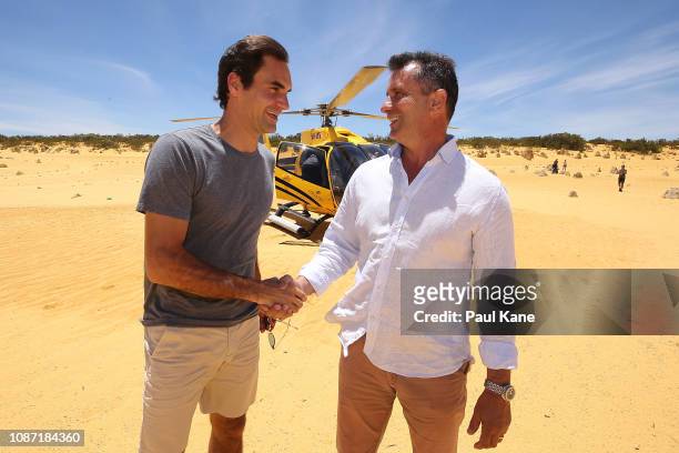 Roger Federer is greeted on arrival at the Pinnacles Desert by West Australian Minister for Tourism Paul Papalia ahead of the 2019 Hopman Cup on...