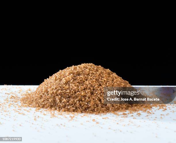organic sugar mound brown on a white background. - brown sugar cubes stock pictures, royalty-free photos & images